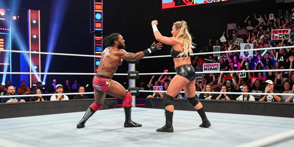 Xavier Woods and Paige wrestling match showcasing their dynamic performance and audience excitement